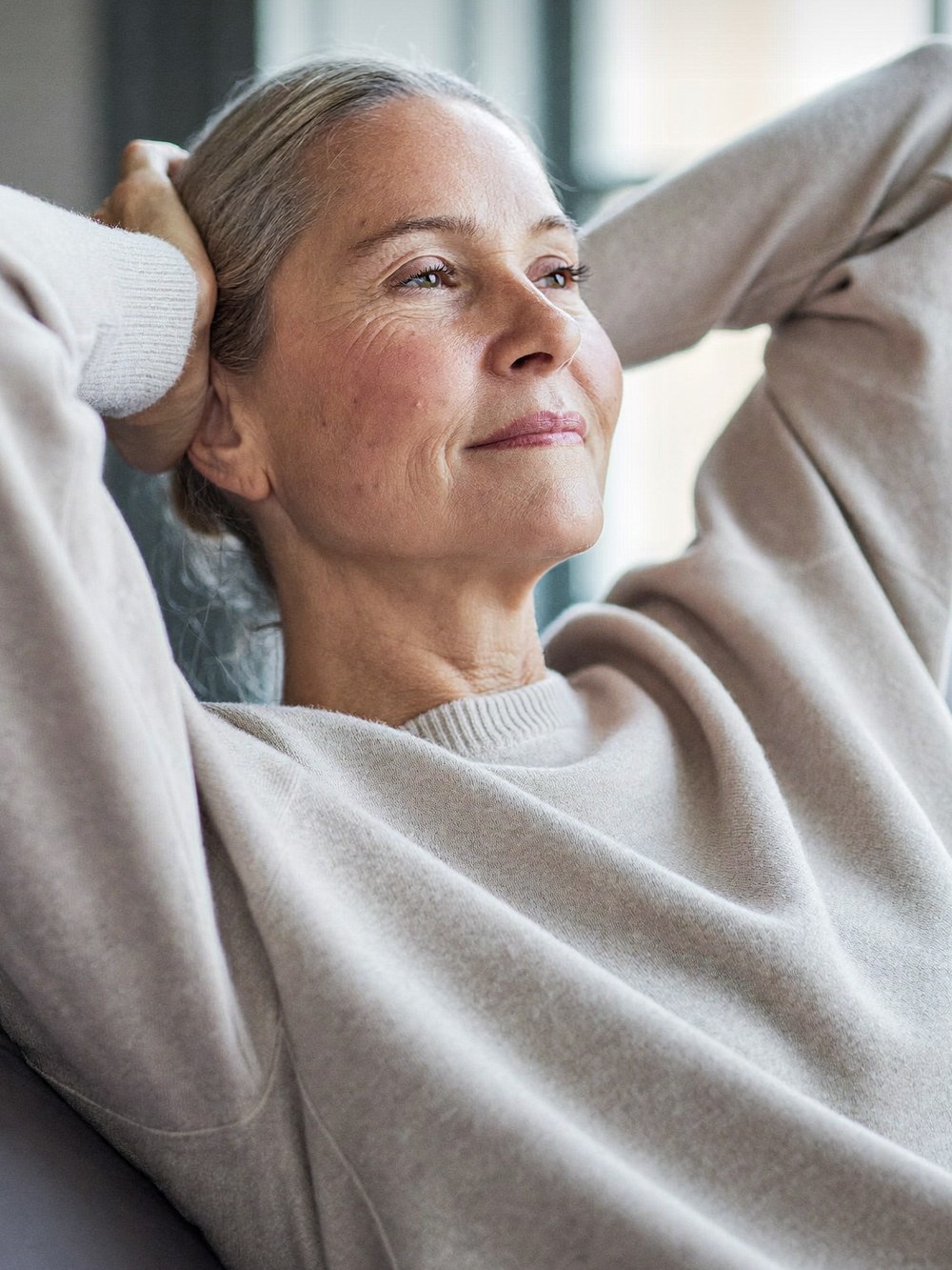 A woman resting comfortably at home, looking calm and refreshed
