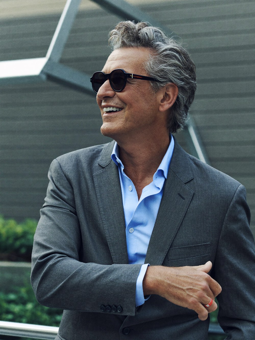A confident, distinguished man in his fifties, looking relaxed and refreshed