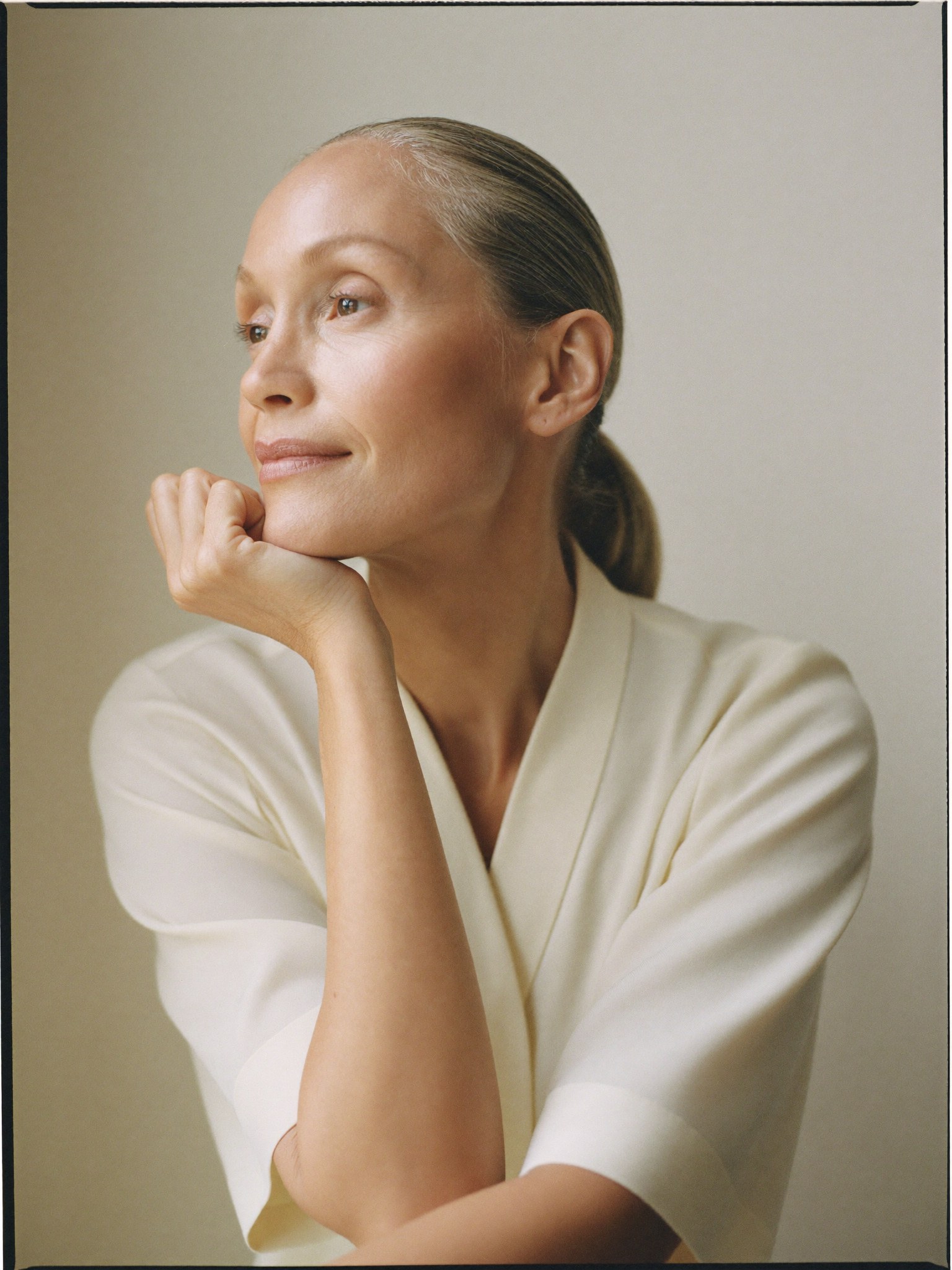 A refined woman in natural light — the kind of rested, natural result a deep-plane approach is designed to give.